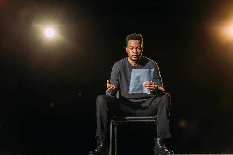 Man seated reading a script